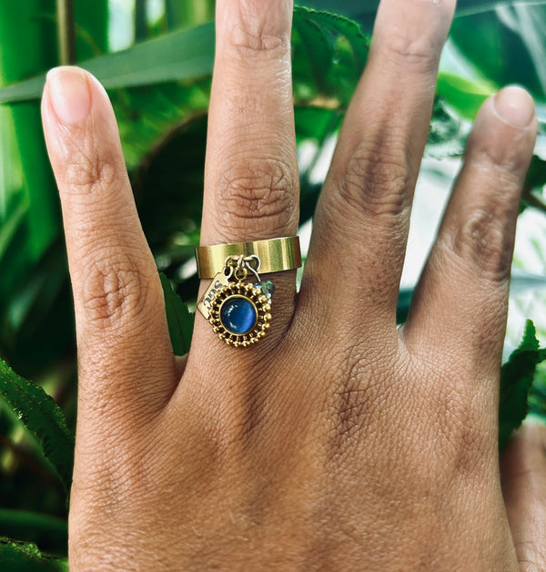 Gold ring with a blue gemstone background